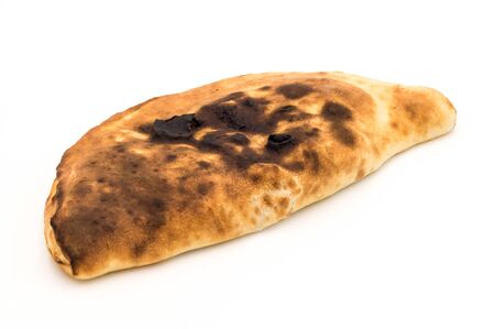 Baked in calzone - closed type of pizza which is folded in half on a white backgroundの写真素材