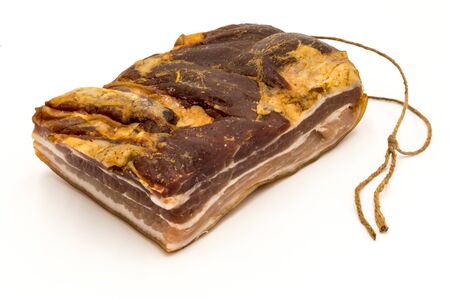 Block smoked bacon with its drying rope on a white backgroundの写真素材