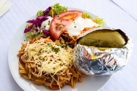 plate of raw vegetables, tomatoes, Greek pasta, potatoの写真素材