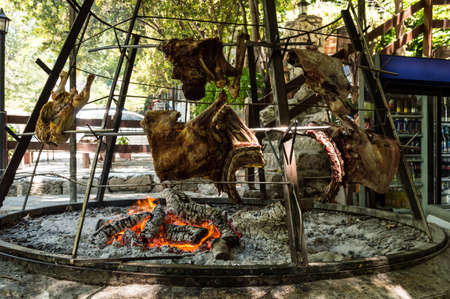 special greek oven with cooking meat over open fire, chicken and lambの写真素材