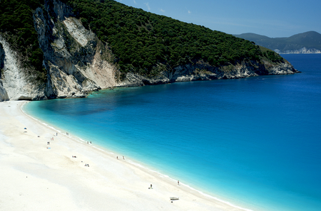 Myrtos beach, Kefalonia, Greece. Sunbathers enjoying the bone-white sands and azure sea of Kefalonia's Myrtos beach, one of the most idyllic beaches of the Greek islands.の写真素材