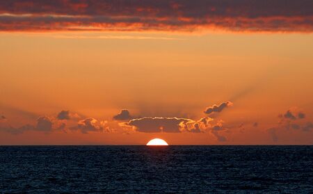 sunset over the Atlantic Ocean off the coast of Cornwall.の写真素材