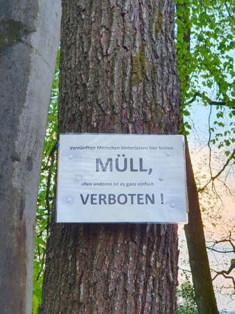 Funny Sign at a parking spot - dont leave your waste behind when you are stupidの写真素材