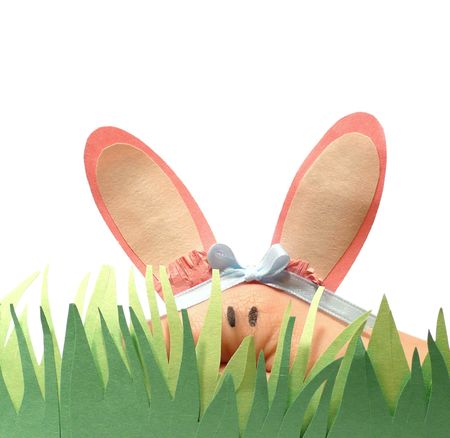 Easter bunny hand puppet with paper grassの写真素材