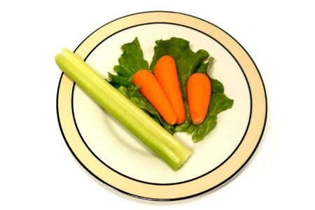 Small meal portion of vegetables isolated on whiteの写真素材