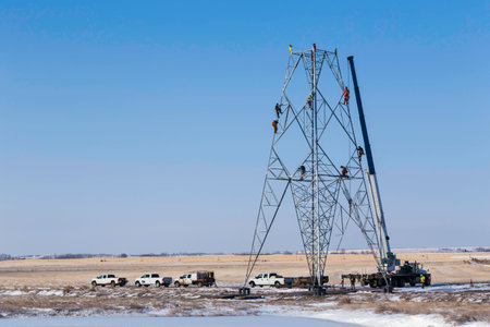 Construction Workers Building a Power Towerの写真素材