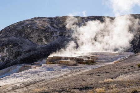 Yellowstone National Park, Wyoming, United States September 20, 2014 â Geothermal activity in Yellowstone carving interesting patterns in the rock and steam rising from the heat.のeditorial素材