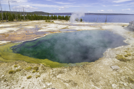 yellowstone National Park, Wyoming, United States September 20, 2014 ? Yellowstone Lake in the background and a geothermal pool of steaming water near the shore.のeditorial素材