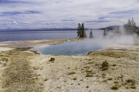 Yellowstone National Park, Wyoming, United States September 20, 2014  Yellowstone Lake in the and a geothermal pool of steaming water near the shore.のeditorial素材