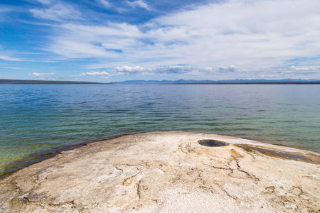 yellowstone National Park, Wyoming, United States September 20, 2014 â Yellowstone Lake with a small volcano like geyser rising from above the water.の写真素材