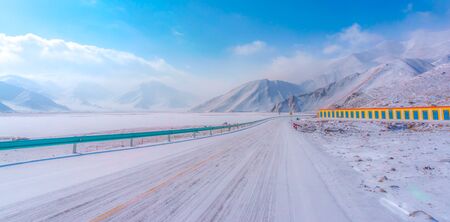 View of travel  road and see view snow mountain in background.の写真素材