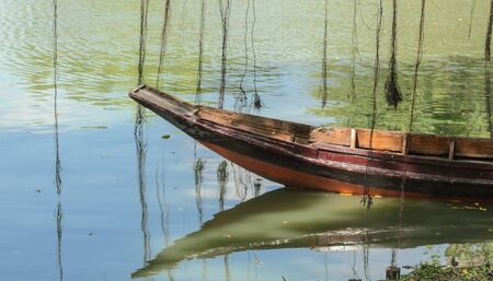 Thai row boat floating in a canal.の写真素材