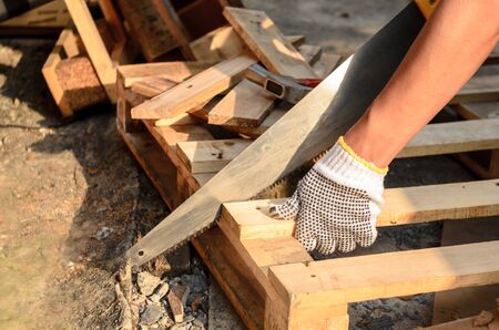 Carpenter Sawing Wood.