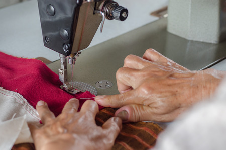 Hand woman seamstress work on the sewing-machine