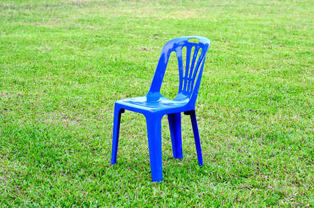 Blue plastic chair on yardの写真素材