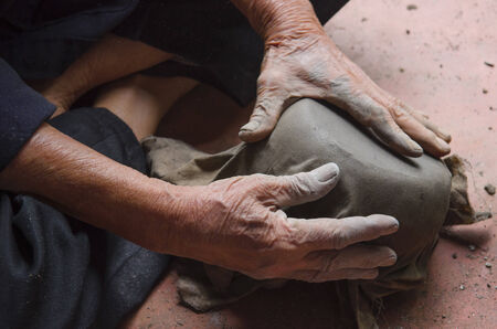 Man shaped a clay work from coconut shellの写真素材