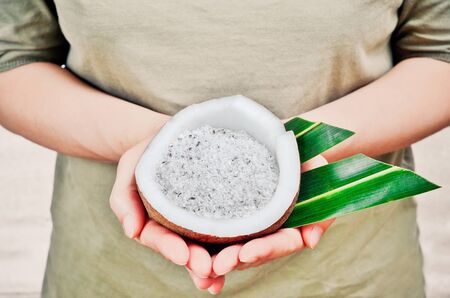 Coconut and grounded coconut flakes on handsの写真素材