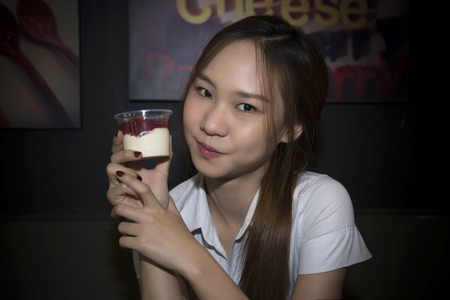 Asia woman show Panna cotta (Cooked Cream) on hand.の写真素材