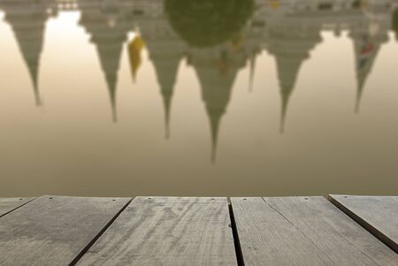 Defocus and blur image of terrace wood and Reflect of Ancient pagoda at Wat asokaram of Samutprakarn Province Thailand for background usageの写真素材