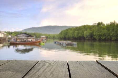 Defocused and blur image of terrace wood and beautiful seascape and fisherman in morning view for background usageの写真素材