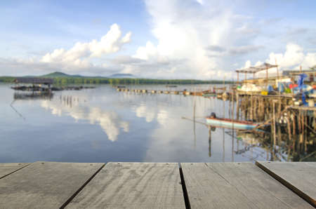 Defocus and blur image of terrace wood and Beautiful seascape and jetty in morning time for background usageの写真素材