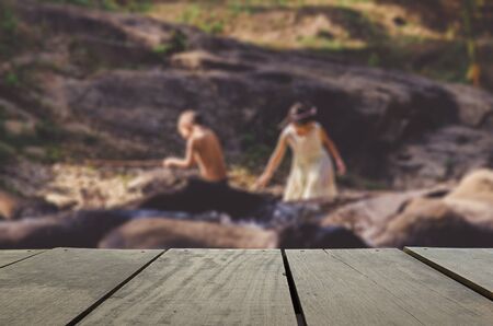 Defocus and blur image of terrace wood and children playing water stream for background usageの写真素材
