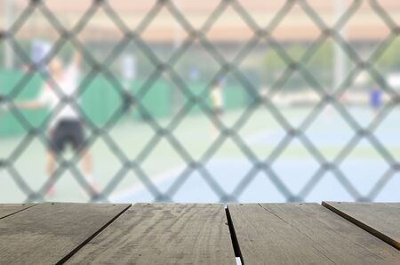 Defocus and blur image of terrace wood and tennis court with tennis ball for background usageの写真素材