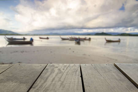 Defocus and blur image of terrace wood and Beautiful beach for background usageの写真素材