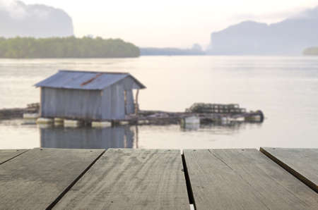 Defocus and blur image of terrace wood and Beautiful seascape in morning time for background usageの写真素材