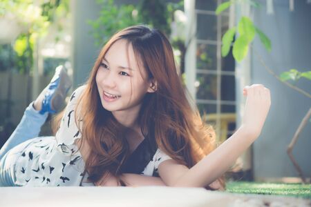 Beautiful girl relax on ground in the morningの写真素材