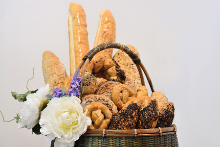 Assortment of baked goods in basket isolate on grey background.の写真素材