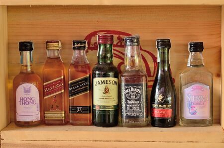 Collection of Bottles and glasses of assorted alcoholic beverages.のeditorial素材