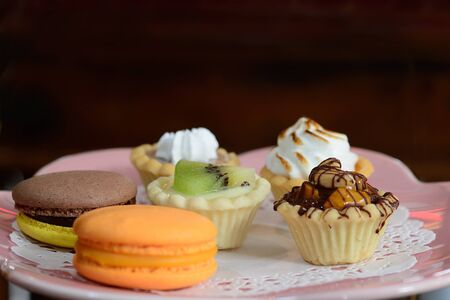 Dessert tartlet with magaron and kiwi fruit mixed on plateの写真素材