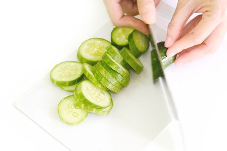 Cucumber and slices isolated over white background