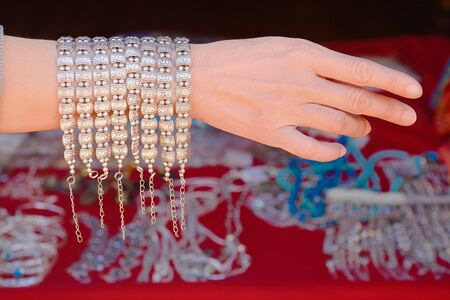 Silver bracelet show on handsの写真素材