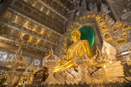 Golden ancient buddha in The silver ubosot (ordination hall) of Wat Srisuphan Temple ,Chiangmai ,Thailandのeditorial素材