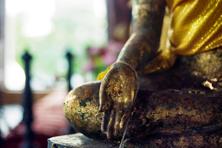 Buddha's hand close up as background donated by Thailand's people for Buddhist relegionの写真素材