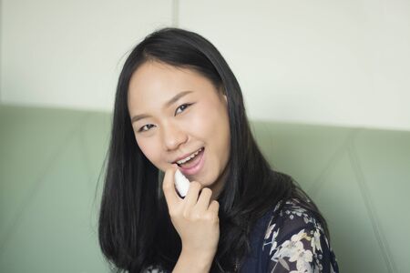 Asia woman with house dust allergy using asthma sprayの写真素材