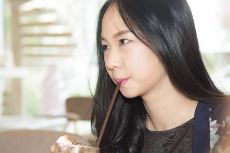 Beautiful asia woman enjoy eatingの写真素材