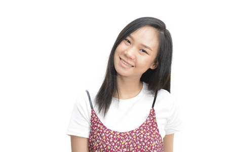 Asian woman smiling and looking at camera over white backgroundの写真素材