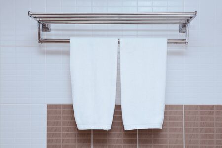 White Towel hanging on Bathroom wall with hanging towelの写真素材