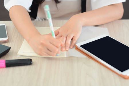Closeup Of Student Hands Writing On Paper