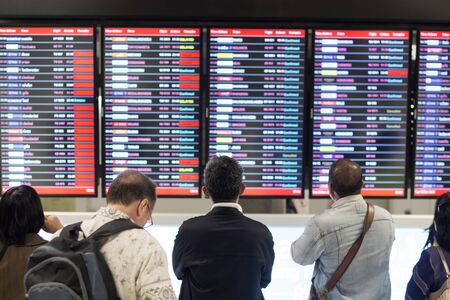 Passanger standing in front of arrivals board in Suvarnabhumi Airport SAMUTPRAKAN THAILANDのeditorial素材