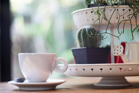 Coffee in white cup on desk as backgroundの写真素材