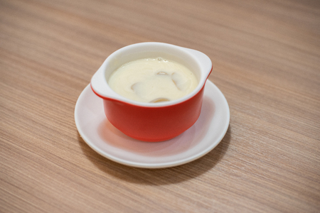 Mushroom cream soup in cup on the tableの写真素材