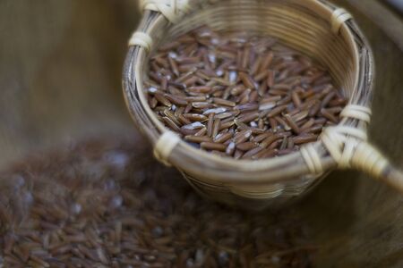 Jasmine brown rice beery in bamboo basket, healthy food and diet concept.の写真素材