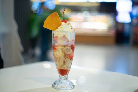 Icecream sundae with whipping cream as backgroundの写真素材