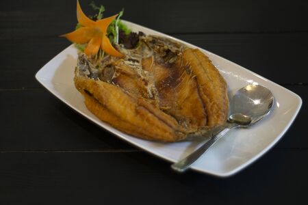 Fried Fish with Fish Sauce Pla Kra Pong Tod Nam Pla. This is a popular menu in thai restaurant.