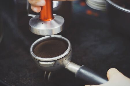 Making espresso with freshly ground coffee and machineの写真素材