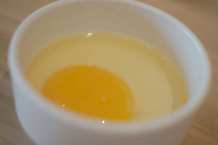 Raw egg in cup for food background